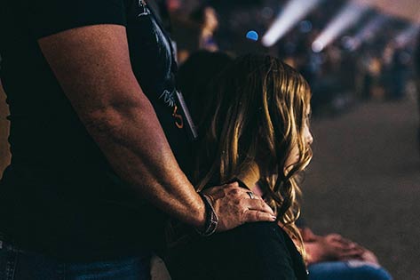 Young woman receiving healing prayer from prayer partner