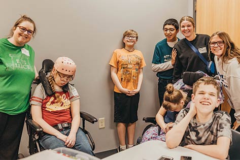 One Body Special Needs volunteers and students smiling as a group