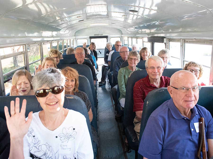 50+ group traveling on bus to an event