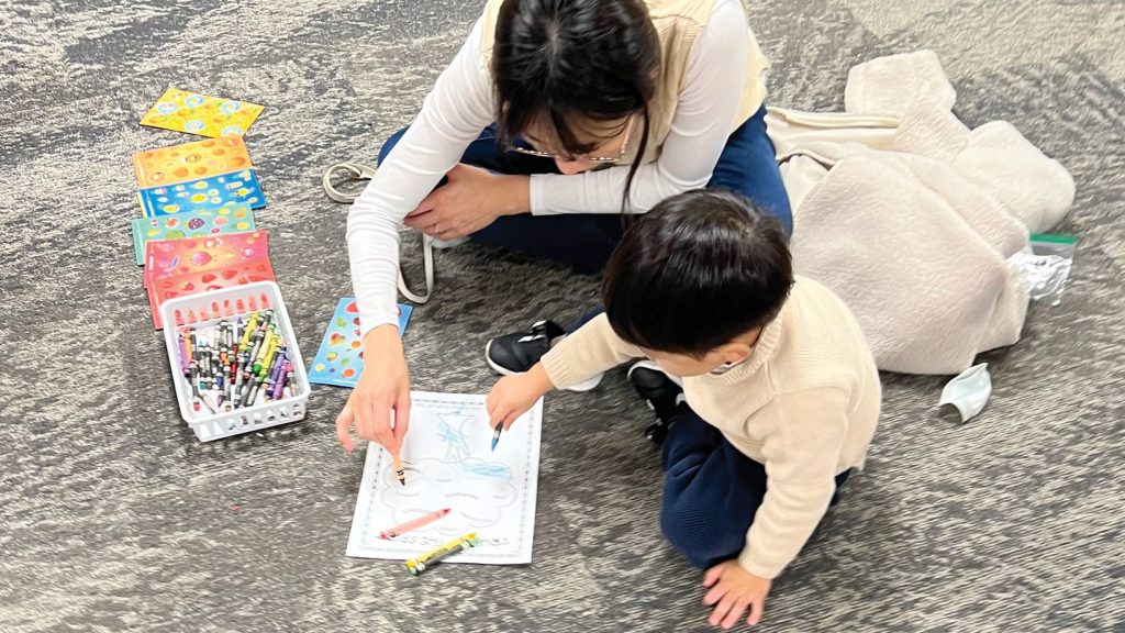 Mother and son coloring together.