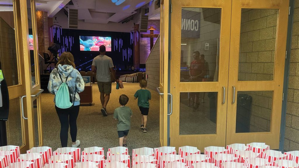 Family walking into Worship Center for Family Movie Night.