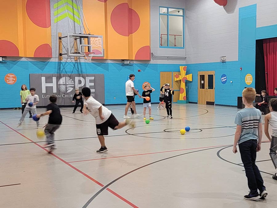 Boys playing dodgeball in the gym.