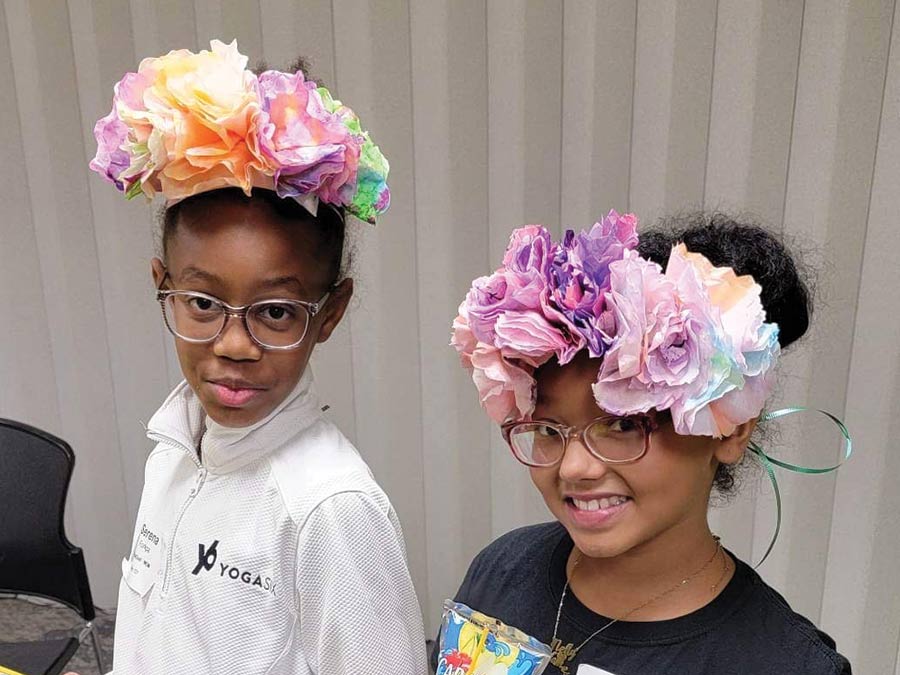 Two girls wearing their flower crown crafts from Girls 4 God festivities.