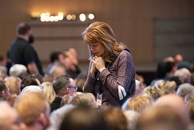 Woman praying at church service