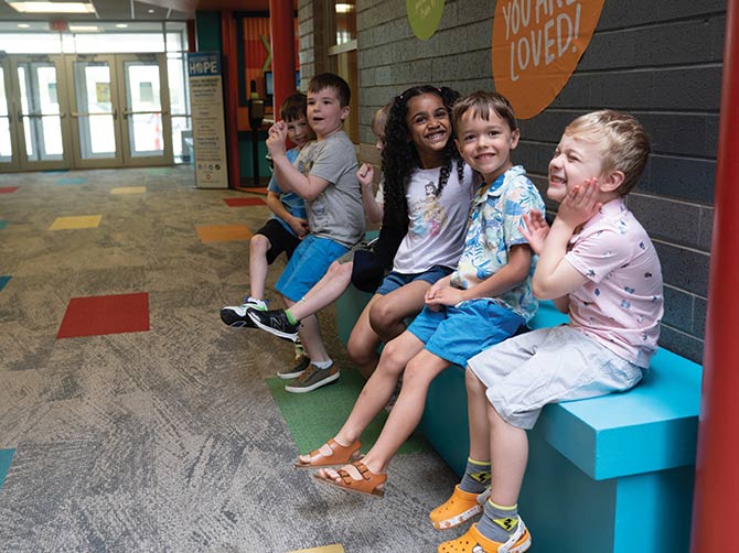 Kids smiling on hallways bench