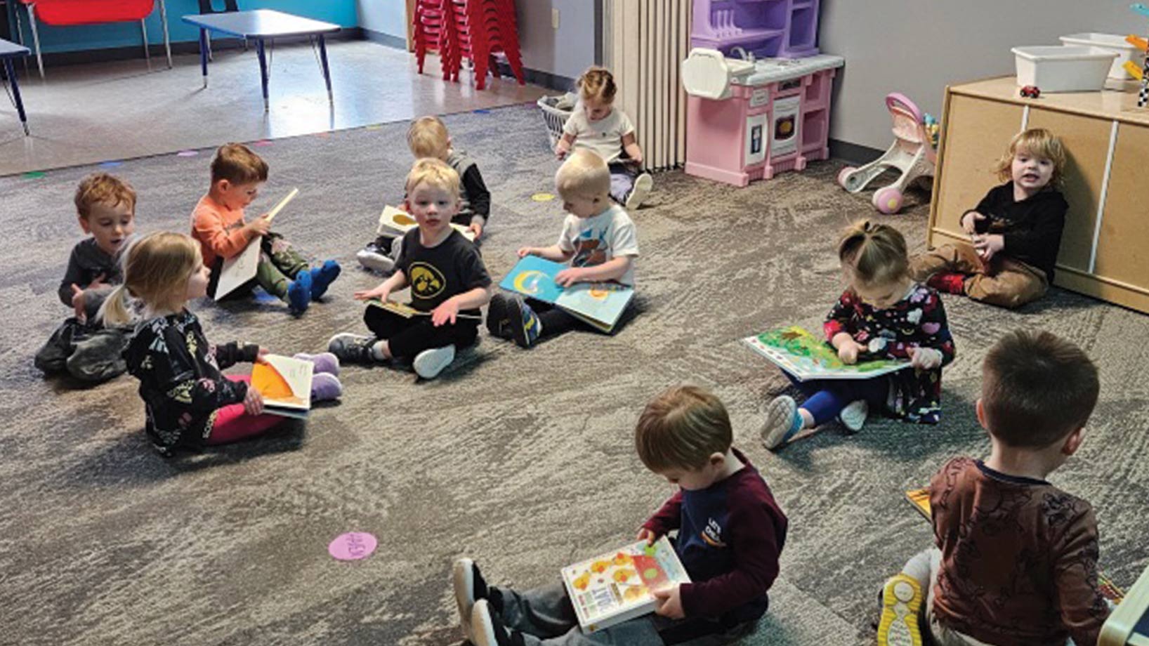 Classroom of kids sitting and flipping through picture books
