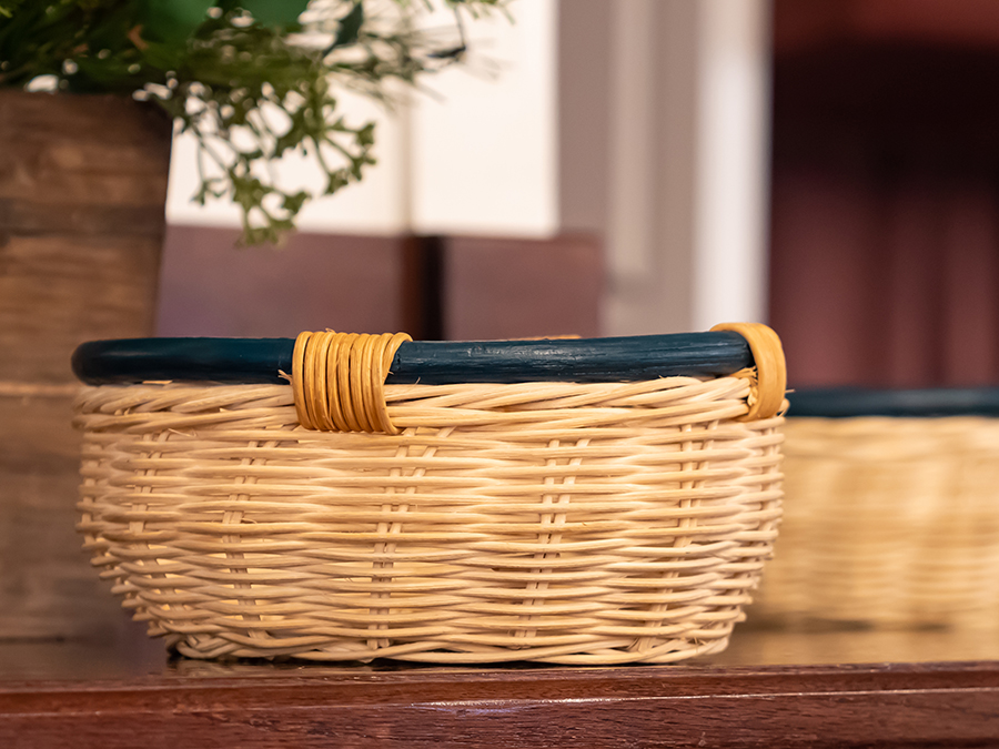Offering baskets resting on a wooden table in front of the churc