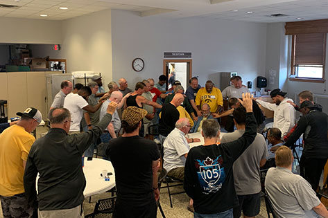 men praying for each other