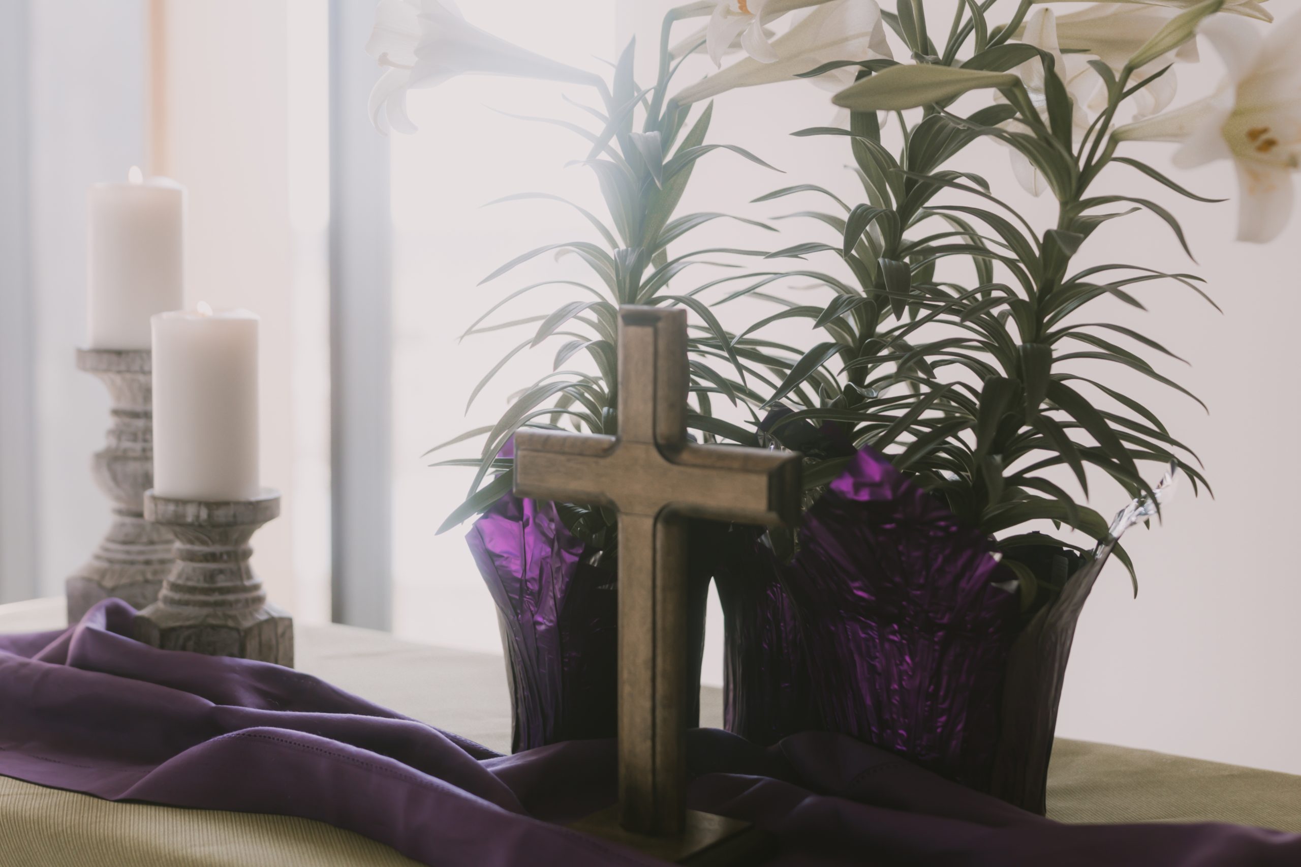 Image of altar in the worship center at Lutheran Church of Hope Grimes with cross, flowers, and candles