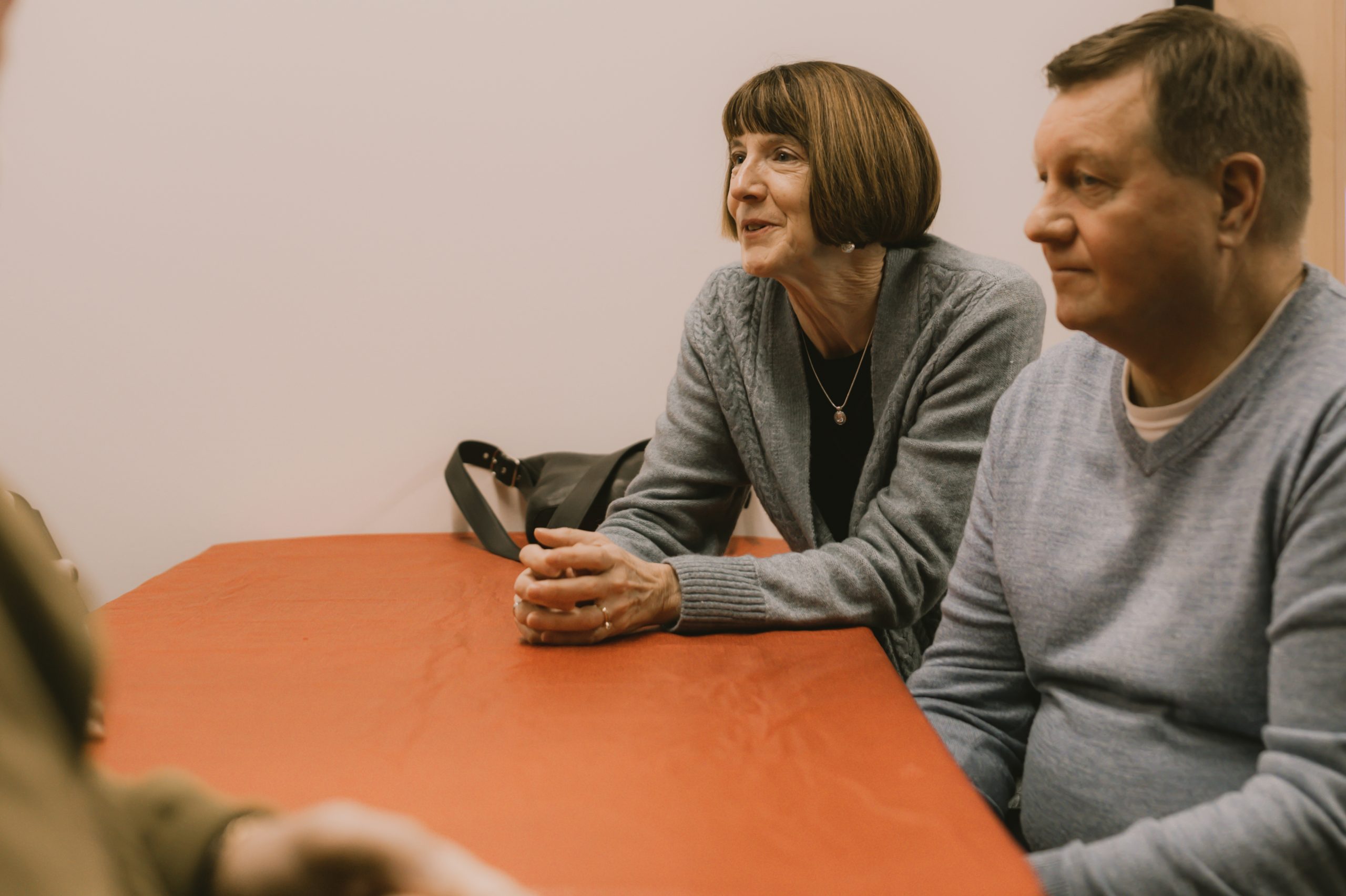 Two adults sitting at a table with their small group after a church service