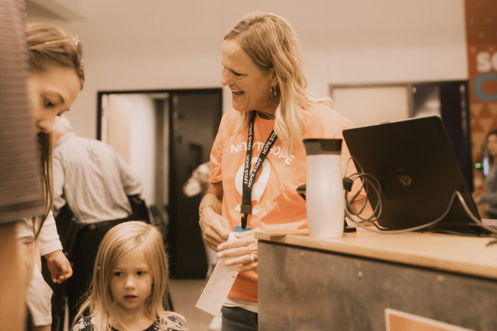 Administrative director registering children for youth ministry event