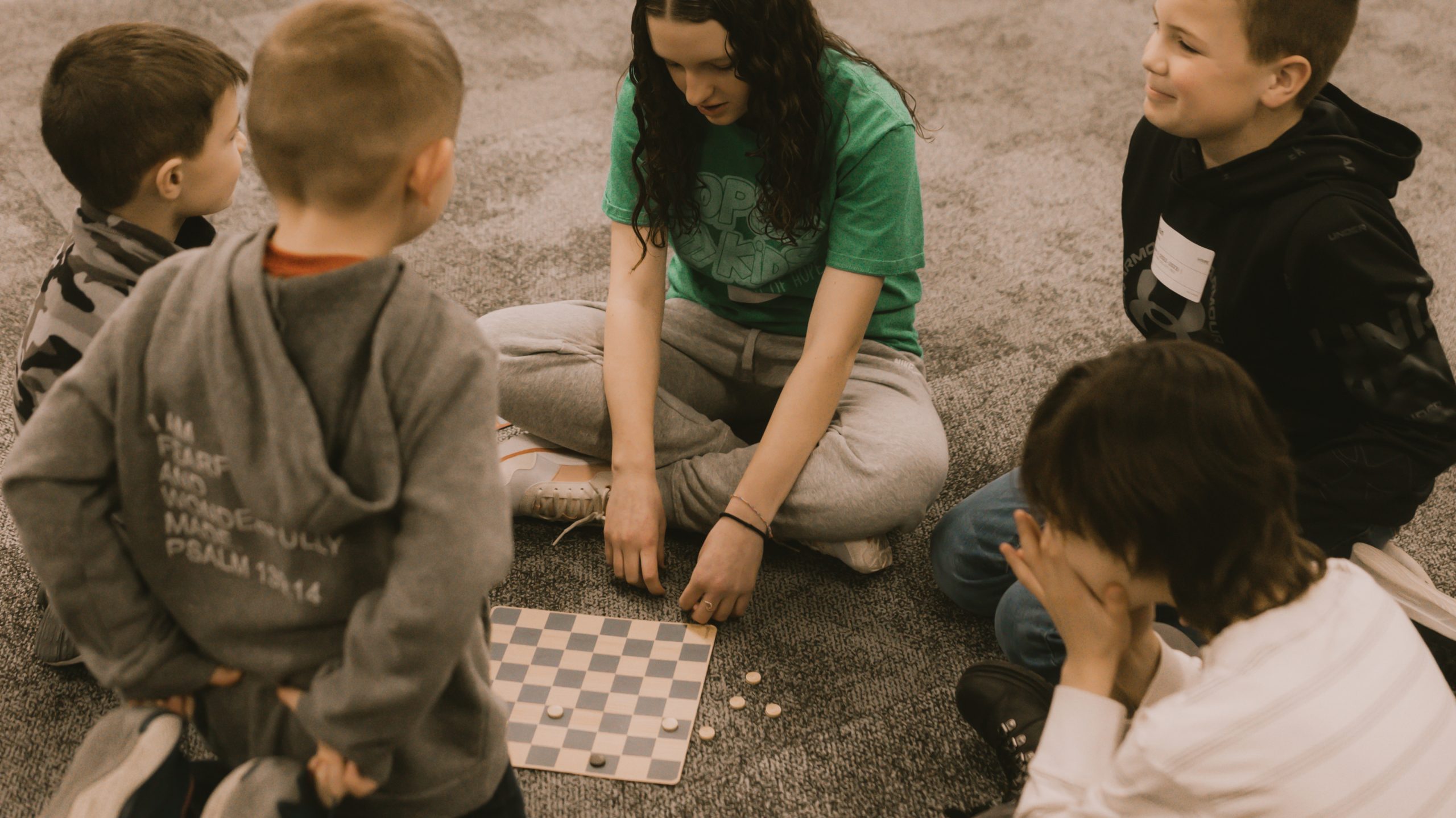 Children at HopeKids playing a game in a circle with their leader and friends