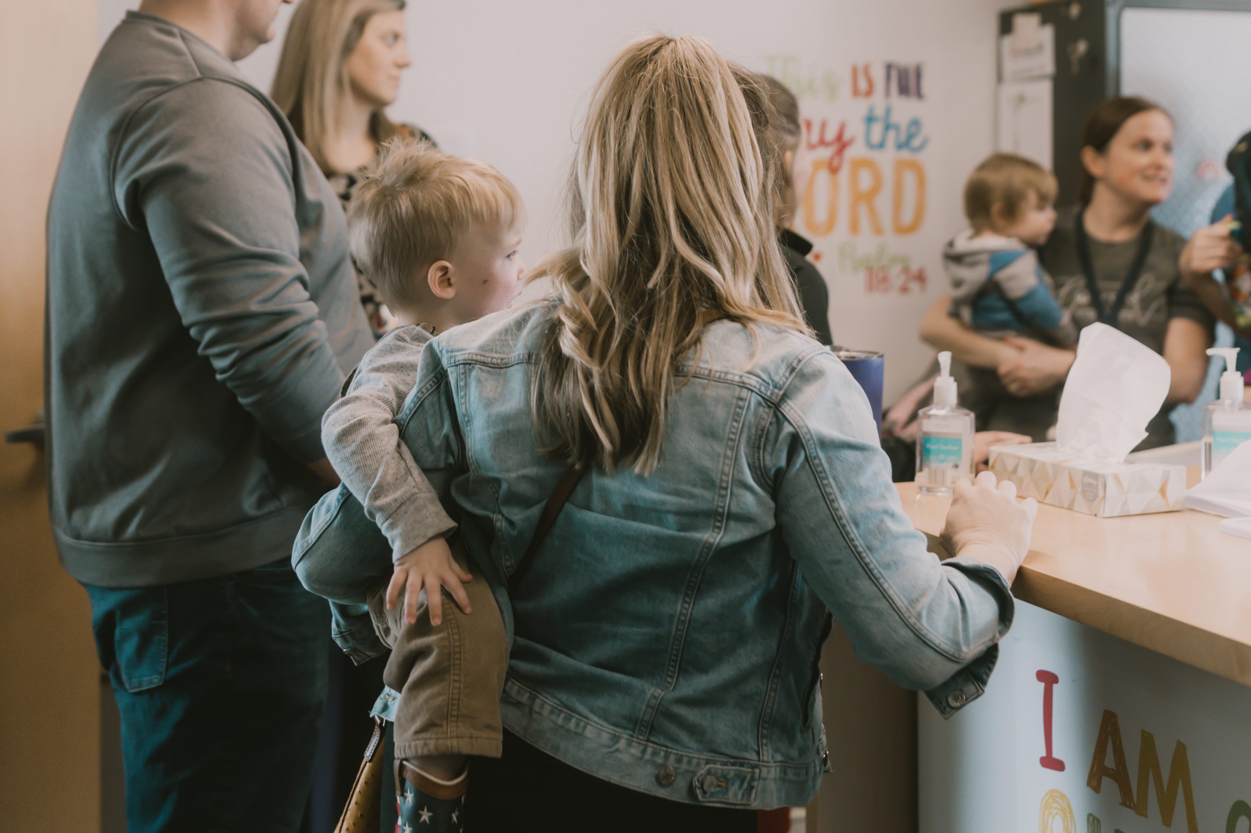 Mother registering child for nursery on Sunday during service