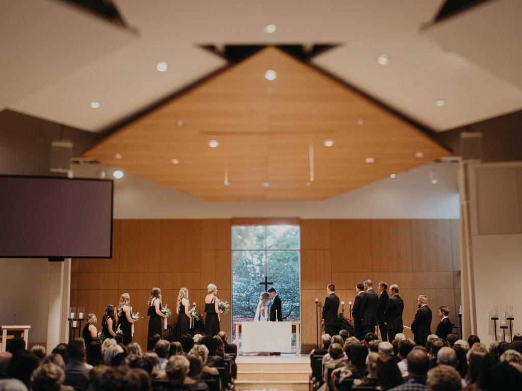 A wedding party and guests in the WDM chapel