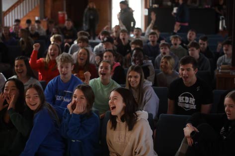 Rows of Ignition students in pews laughing